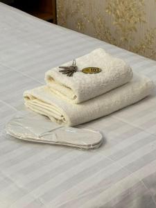 two towels sitting on top of a bed at Uya Nest Osh in Osh