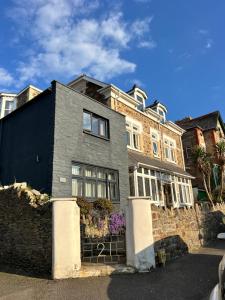a brick house with a fence in front of it at torrs view apartment in Ilfracombe