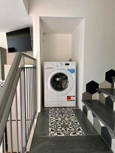 a washing machine in a room with a staircase at Da Feny in Massa Lubrense