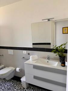 a bathroom with a sink and a toilet and a mirror at Da Feny in Massa Lubrense +18 photos