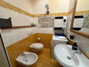 a small bathroom with a sink and a toilet at Maison Angèle in Saint Nicolas +17 photos