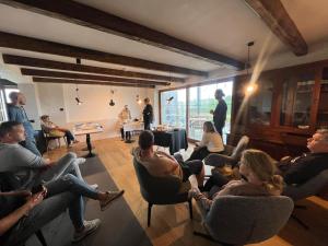 a group of people sitting in chairs in a room at Vila Mill in Sveti Jurij ob Ščavnici
