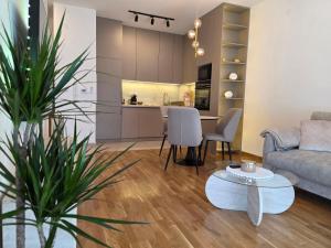 a living room with a couch and a table at Gold Apartman in Pančevo +22 photos