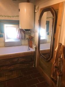 a bathroom with a mirror and a window and a sink at Sedliacka drevenica in Liptovská Osada +48 photos