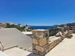 a stone wall with the ocean in the background at Vromolithos View House in Vromolithos