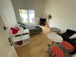 a bedroom with a bed and a living room at Grande Chambre avec parking possible en supplément, BORDEAUX BASTIDE in Bordeaux