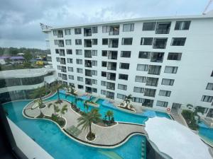an aerial view of a large building with a swimming pool at Stylish Pool View 1BDR Apartment Bang Tao in Ban Thalat Choeng Thale +15 photos