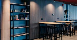 a row of tables and stools in a room at Tallink Express Hotel in Tallinn