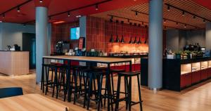 a bar in a restaurant with stools at Tallink Express Hotel in Tallinn +44 photos