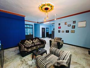 a living room with couches and a blue wall at Royal Villa Pondy in Pondicherry +1 photo