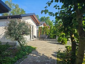 a garden with a patio and a house at Domki Cztery Pory Roku in Czchów