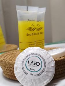 a bottle of soap and a paper plate on a table at MMrooms Μονά κρεβάτια 2ος όροφος in Tinos