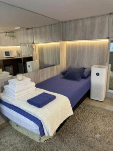 a bedroom with a bed with towels on it at Central Luxury Studio in Chişinău