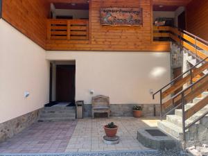 a patio with a staircase and a chair in a building at Apartmány Limba in Belá