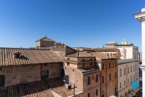 a view of the roofs of buildings at TriplyRooms Collection - Roma Prassede in Rome