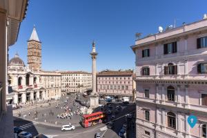 a busy city street with a red double decker bus at TriplyRooms Collection - Roma Prassede in Rome