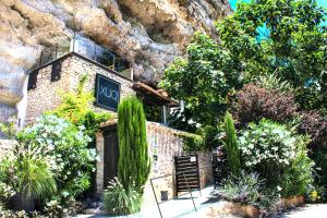 a building with a sign on the side of a mountain at XUQ Hotels Lomas de Ruvira in Jorquera