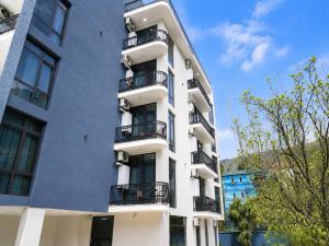 an apartment building with balconies on the side of it at PARALLEL Apartments in Gonio +128 photos