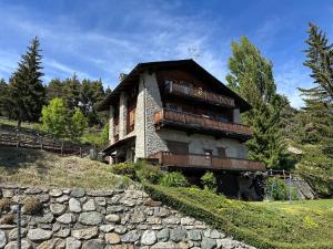 a house on a hill with a stone wall at Maison Angèle in Saint Nicolas