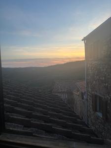 a view from the rooftop of a building at sunset at Borgo Arte in Monteverdi Marittimo