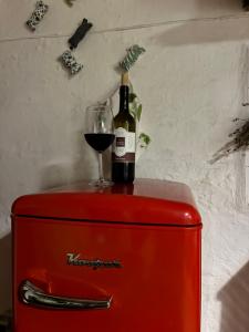 a bottle of wine and a glass on top of a refrigerator at Borgo Arte in Monteverdi Marittimo