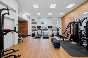 a gym with several treadmills and tread machines at Hotel Alte Post Flensburg in Flensburg