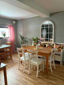 a dining room with a wooden table and chairs at Rödlix Vandrarhem & Camping in Tvååker