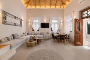a living room with a couch and a table at Archontiko Residence in Koskinou
