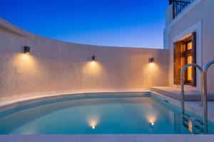 a swimming pool with blue lights in a house at Archontiko Residence in Koskinou