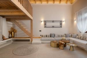 a living room with a couch and a table at Archontiko Residence in Koskinou +18 photos