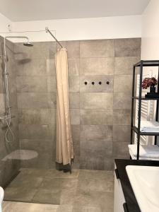 a bathroom with a shower with a shower curtain at New Modern Two bedroom Apartment in Hveragerði +7 photos