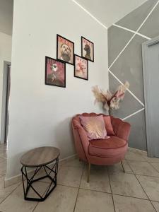 a living room with a chair and a table at Butterfly House in Villaputzu +12 photos