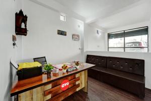 a living room with a desk and a couch at Hotel O Radha Krishna Family Hotel in Naubatpur