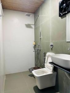 a bathroom with a toilet and a sink at Aashray Independent Homestay Dibrugarh in Dibrugarh +19 photos