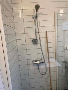 a shower with a hose in a bathroom at Bergen City hostel Rooms in Bergen +33 photos