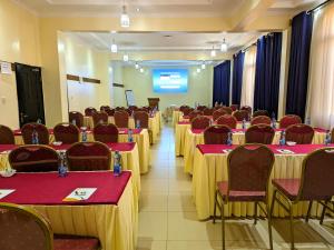 a conference room with tables and chairs and a podium at Peaks Hotel Nanyuki in Nanyuki +43 photos