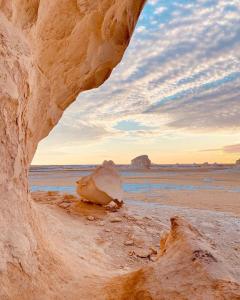 a view of a beach with a rock and the ocean at White Desert Experience in Bawati