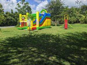 a playground in a park with a play structure at Peaks Hotel Nanyuki in Nanyuki