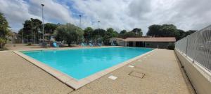 a large swimming pool with blue water at Mh 229 La Tremblade in La Tremblade