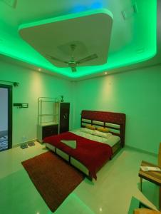 a bedroom with a bed with a green ceiling at Aashray Independent Homestay Dibrugarh in Dibrugarh
