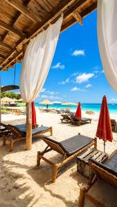a group of chairs and umbrellas on a beach at Zava Nungwi in Nungwi