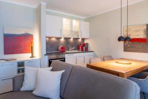 a kitchen with a couch and a table in a room at Wittehuus Wohnung 5 in Borkum
