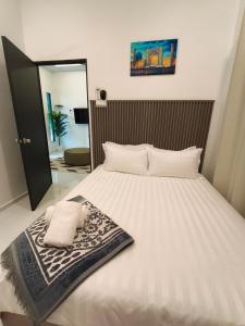 a large white bed with two pillows on it at The Kobe House 2 in Kuala Berang