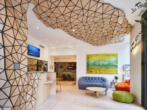 a lobby with a large geometric ceiling at Hôtel Carré Vieux Port in Marseille