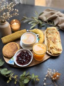 a tray with breakfast foods and a cup of coffee and bread at STUNNING VIEW, chambre en forêt proche BORDEAUX in Bouliac