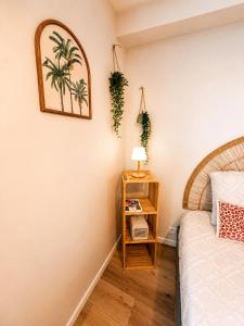 a bedroom with a bed and a nightstand with a lamp at Studio Sunshine Saint-Omer Centre in Saint-Omer