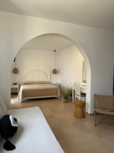 a bedroom with a bed with an archway in it at Esperides in Platis Gialos +39 photos