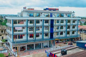 a large white building with a lot of windows at Moveck Inn in Dar es Salaam