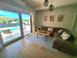 a living room with a couch and a table at Villa Velaris Mostar in Mostar
