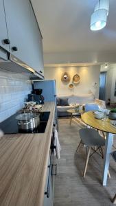 a kitchen with a counter and a table in a room at Kleopatra's Apartments in Chios